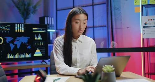 Woman Working at Computer in Modern Office