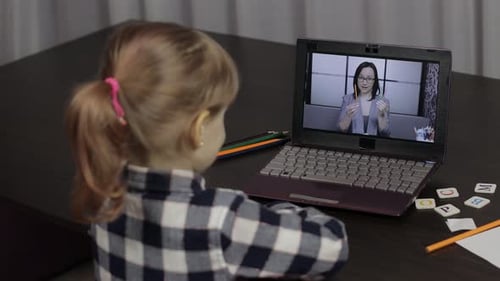 Girl Learning Online With Remote Tutor on Laptop