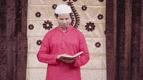 Man in Skullcap Reads from Holy Book