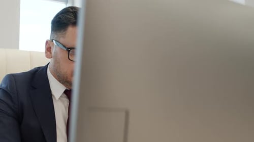 Man in Suit Working at Office Computer