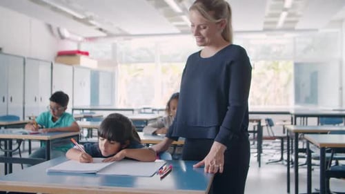 Young Female School Teacher Checking Task