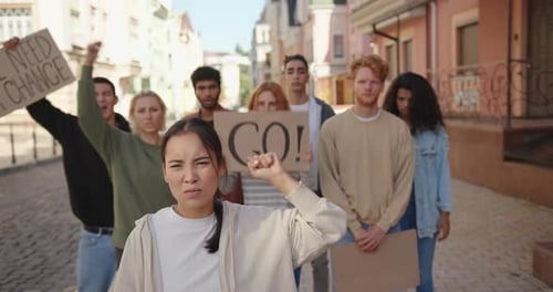 Group of People Raise Fists at Protest