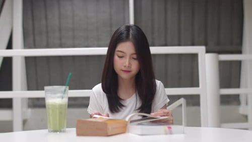 Woman Reading Book with Tea in a Home