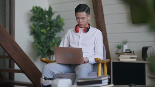 Adult Using Laptop Computer in Home Environment