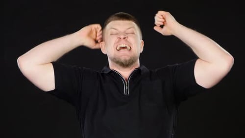 Man Yelling and Pumping Fists in Excitement