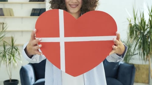 Young Woman Holding Heart Shaped Birthday Gift