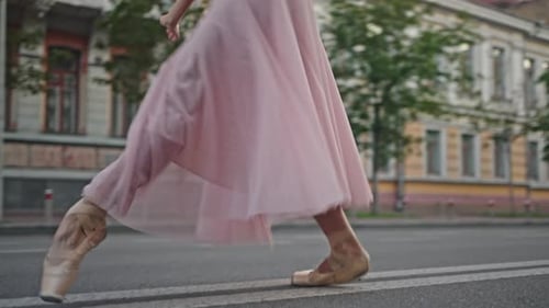 Professional Ballerina in Pointe Shoes Dances on Street