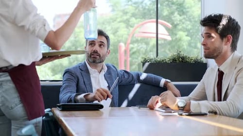 Businessmen during meeting in cafe