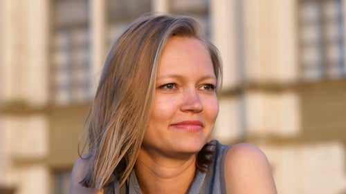 Smiling Woman During Golden Hour in an Urban Setting