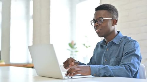 Young Adult Working on Laptop during Video Call