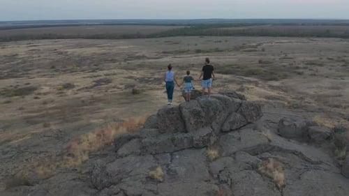 Aerial View. The Family Standing on the Mountain. Mother, Father and Son Went Hiking