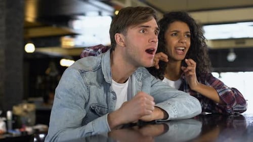 Friends Watching Sports at Bar Reacting to Game