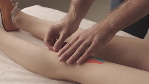 Applying Kinesiology Tape to Knee for Support