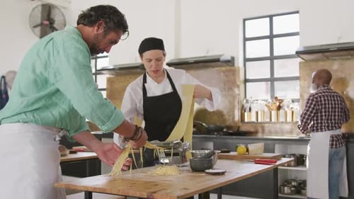 Chefs Making Fresh Pasta in Commercial Kitchen