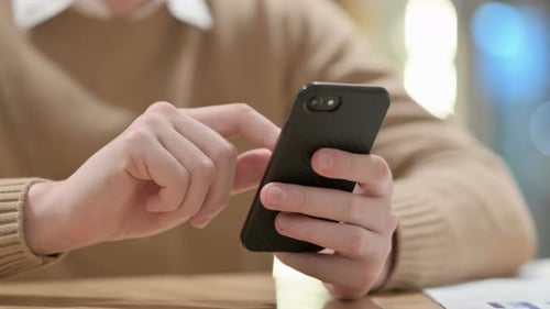 Close Up of Hands of Young Man Using Smartphone