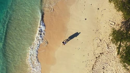 Romantic couple sunbathing on marine tourist beach vacation by transparent lagoon with white sandy b