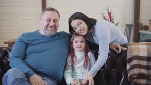 Happy Family Poses Together on Couch