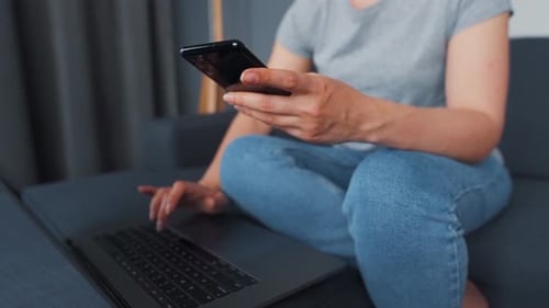 Woman Working from Home with Laptop and Phone
