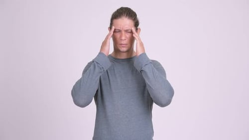Young Adult Rubbing Temples with Headache Pain
