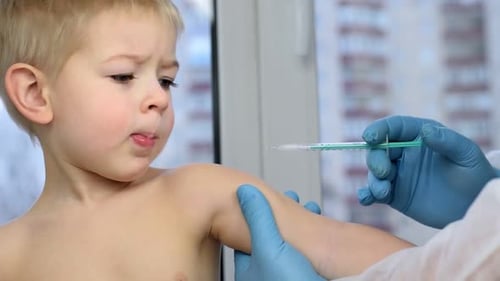 Little Boy Gets Arm Injection in Clinic