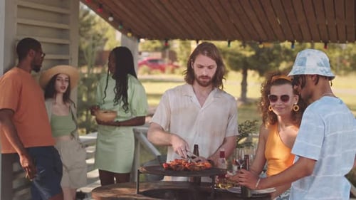 Friends Enjoying Outdoor Barbecue on Summer Day