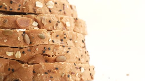 Stacked Slices of Multi-Grain Bread on White Background