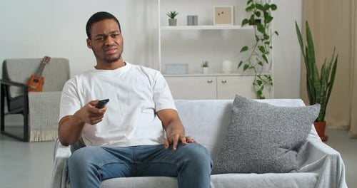 Young Man Reacts Negatively to Television at Home