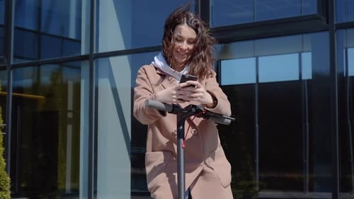 Young Woman Using Phone With Electric Scooter