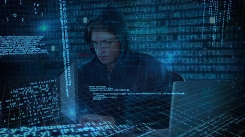 Hacker using computer in dark room