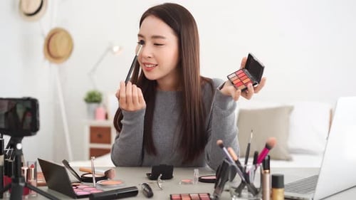 Woman Applies Makeup for Online Beauty Tutorial