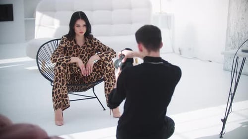 Fashion Model Posing in Studio with Photographer