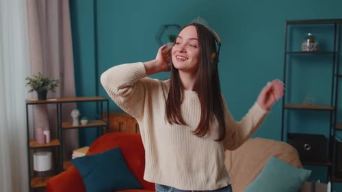 Woman Dancing, Listening to Music on Headphones Indoors