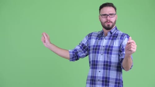 Man Gesturing to Virtual Interface Against Green Screen