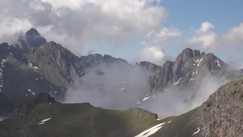 Clouds Passing Around the Sharp Peaks in High Altitude Mountain Climate