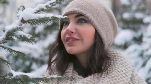 Portrait of a Beautiful Young Girl in a Winter Park Near the Christmas Tree