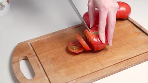 Tomato Slicing on Wooden Cutting Board