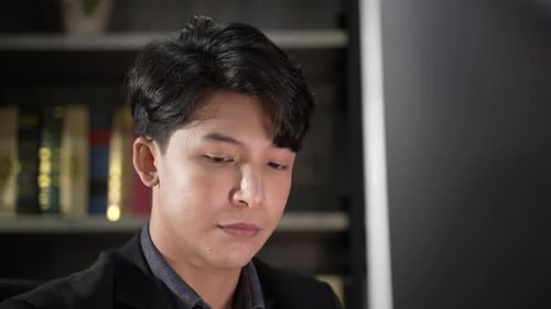 young businessman wearing suit working in business marketing work on computer laptop in home office