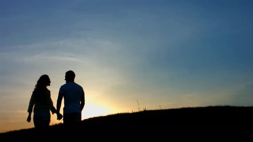 Silhouette of Couple Holding Hands at Sunset
