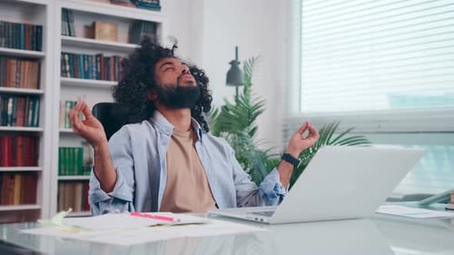 Young Arabian Man Calms Himself Working in Office Does Meditation Pose