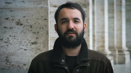 Young Adult Giving Thumbs Up Gesture Outdoors