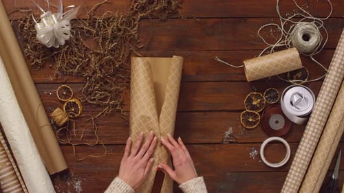 Gift Wrapping on a Wooden Table Top