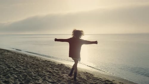 Excited Woman Turning Around on Beach