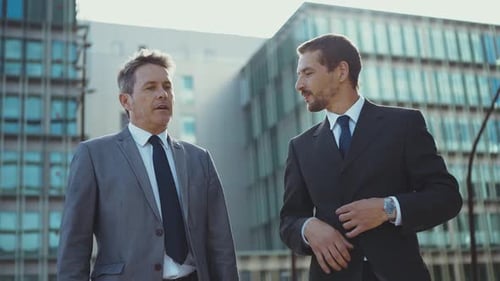 Businessmen Walking and Talking in Urban Setting