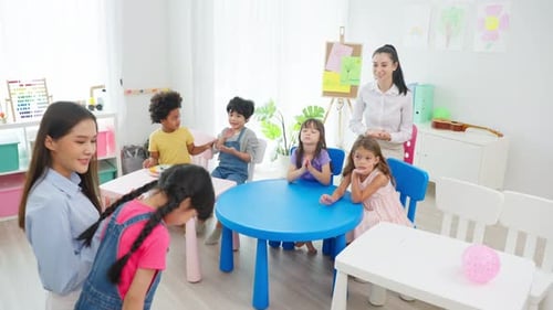 Enthusiastic Young Students Clapping in Classroom with Teacher