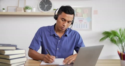 Young Adult Attending Online Meeting at Desk