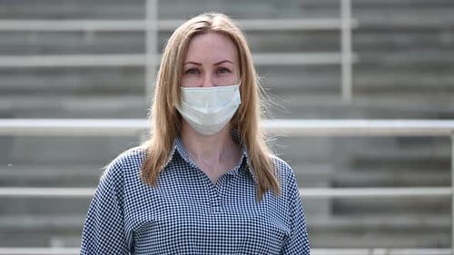 Woman Wearing Medical Mask in Urban Setting