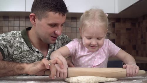 Father and Daughter Baking Together in Kitchen