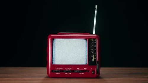 Retro Red Television Displaying Static, Turns Clear