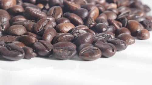 Pile of Roasted Coffee Beans on White Surface
