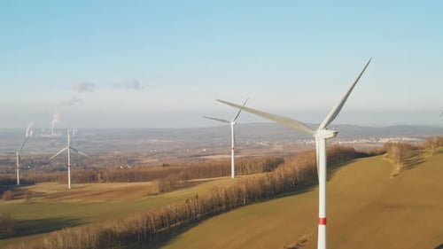 Aerial View of a Farm with Wind Turbines or Windmills at Sunset